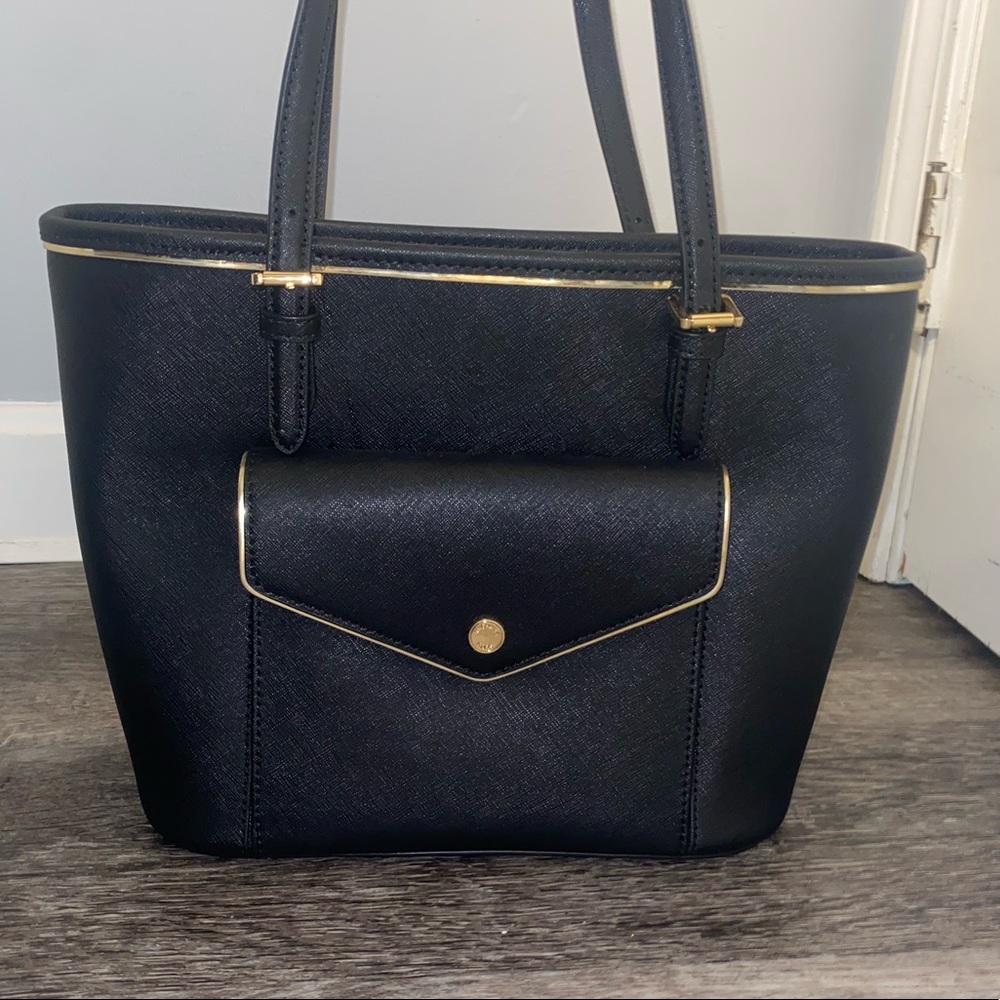 Used once. Black Micheal Kors purse with gold hardware